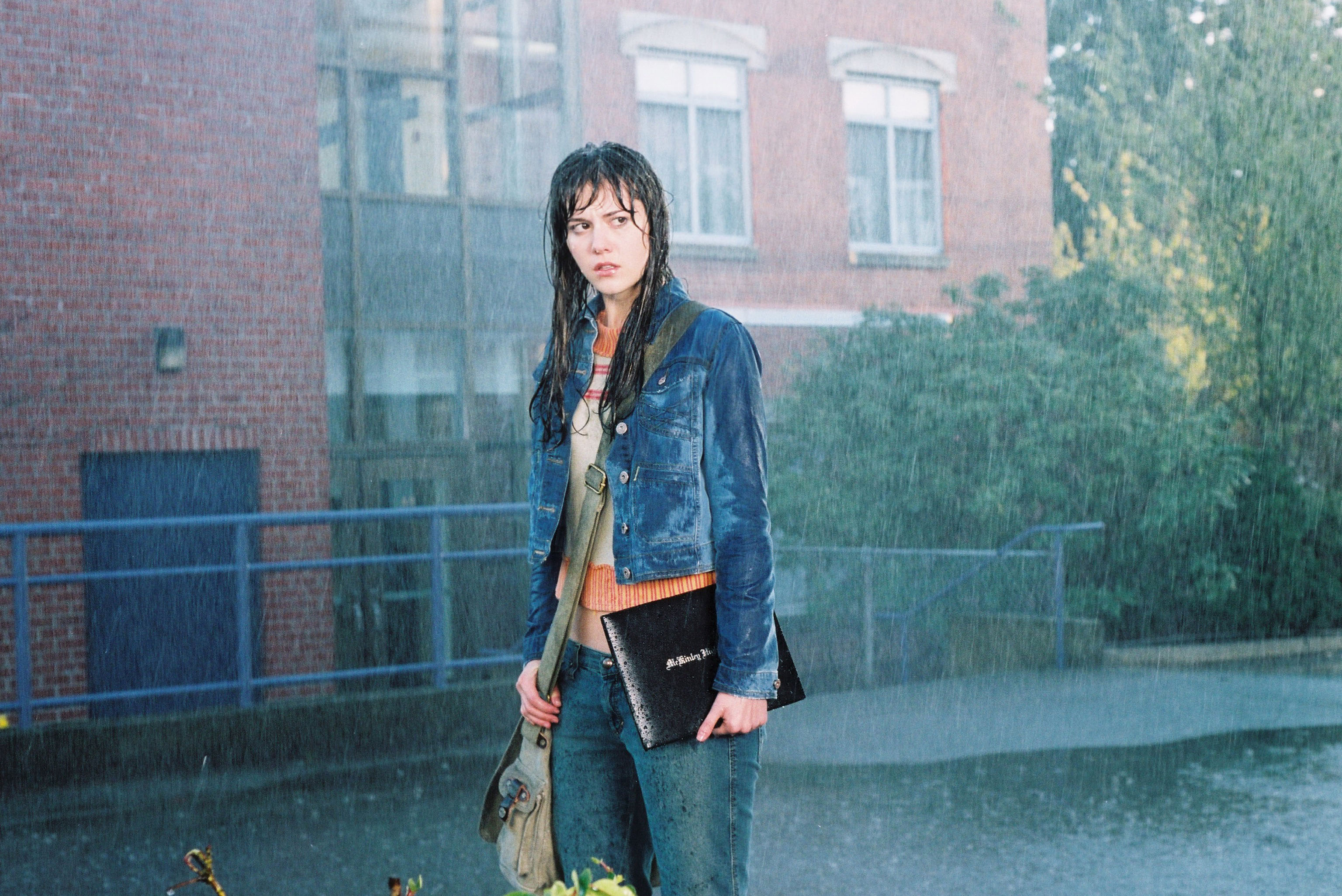 Wendy in the rain outside the school.