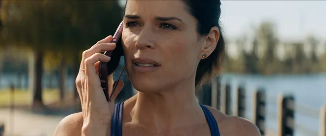 Sidney on the phone outdoors.