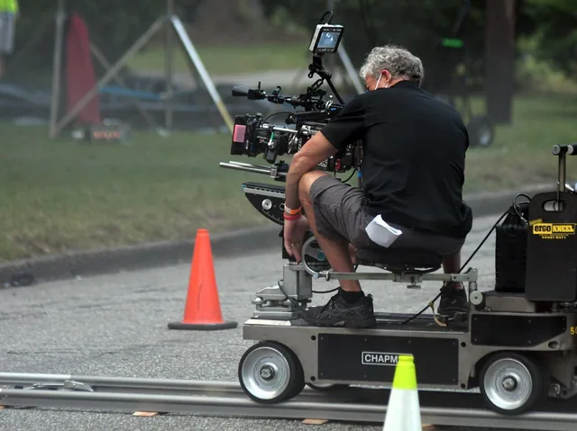 Camera operator on the dolly.