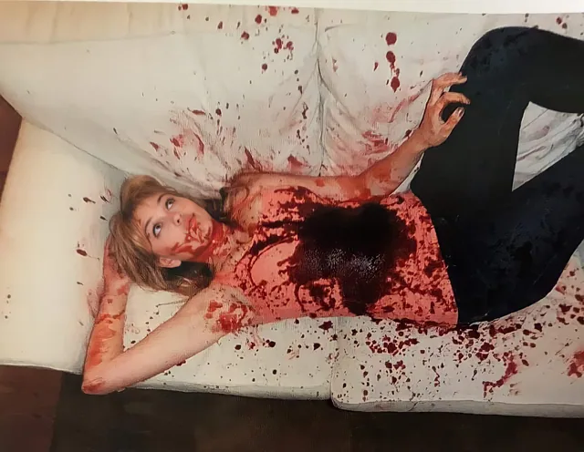 Jenny on the bloodied couch.