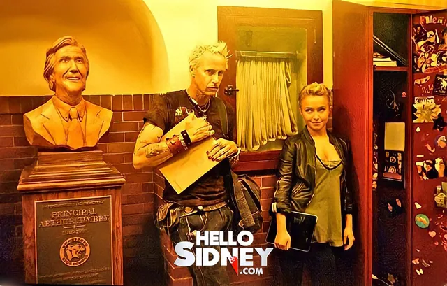 Wes Craven and Hayden Panettiere beside the school bust.