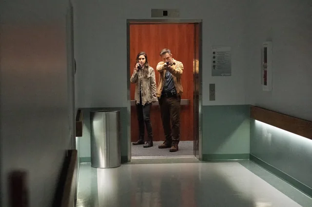 Sam and Dewey in the hospital corridor.