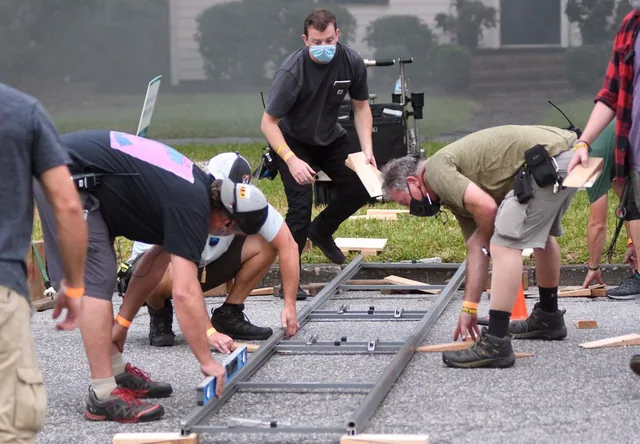 Crew laying camera track on location.