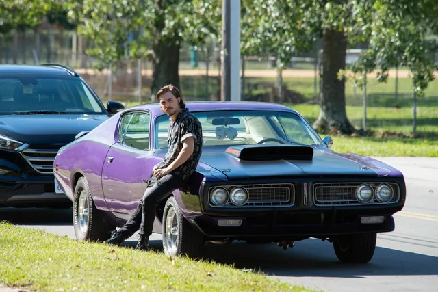 Vince beside his car.