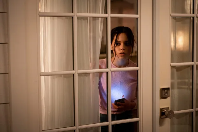 Tara at the glass door.