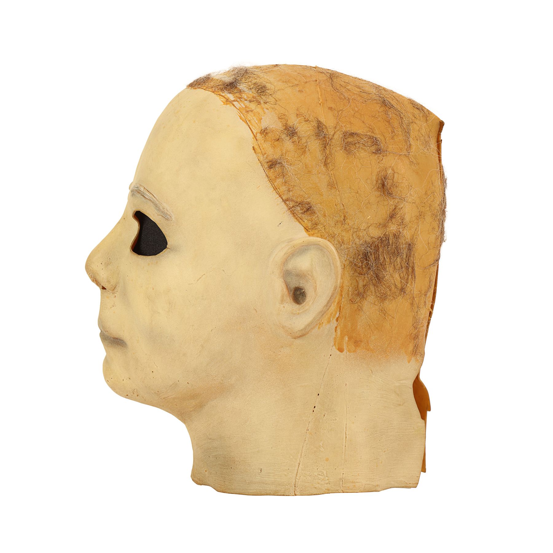 Production-made Michael Myers mask, left profile view. The surviving mask no longer has its hair. Later catalog photograph by Propstore.