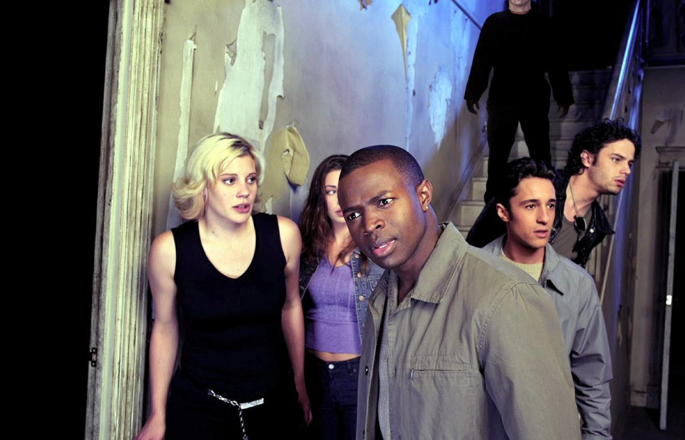 Freddie leads the contestants through the Myers house.