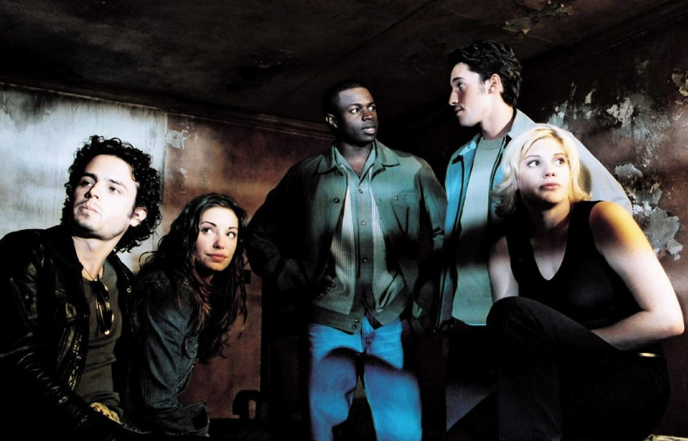 The contestants look around the interior of the Myers house.