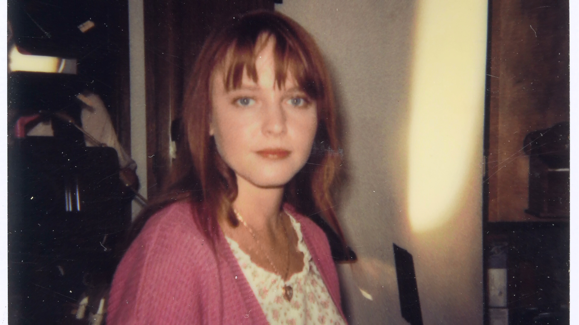 Lisa Wilcox beside camera equipment on the interior set.