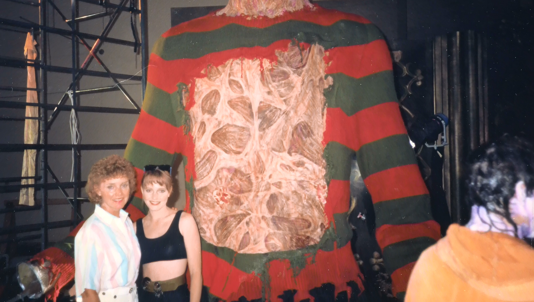 Visitors or crew beside the oversized Freddy torso built for the finale.