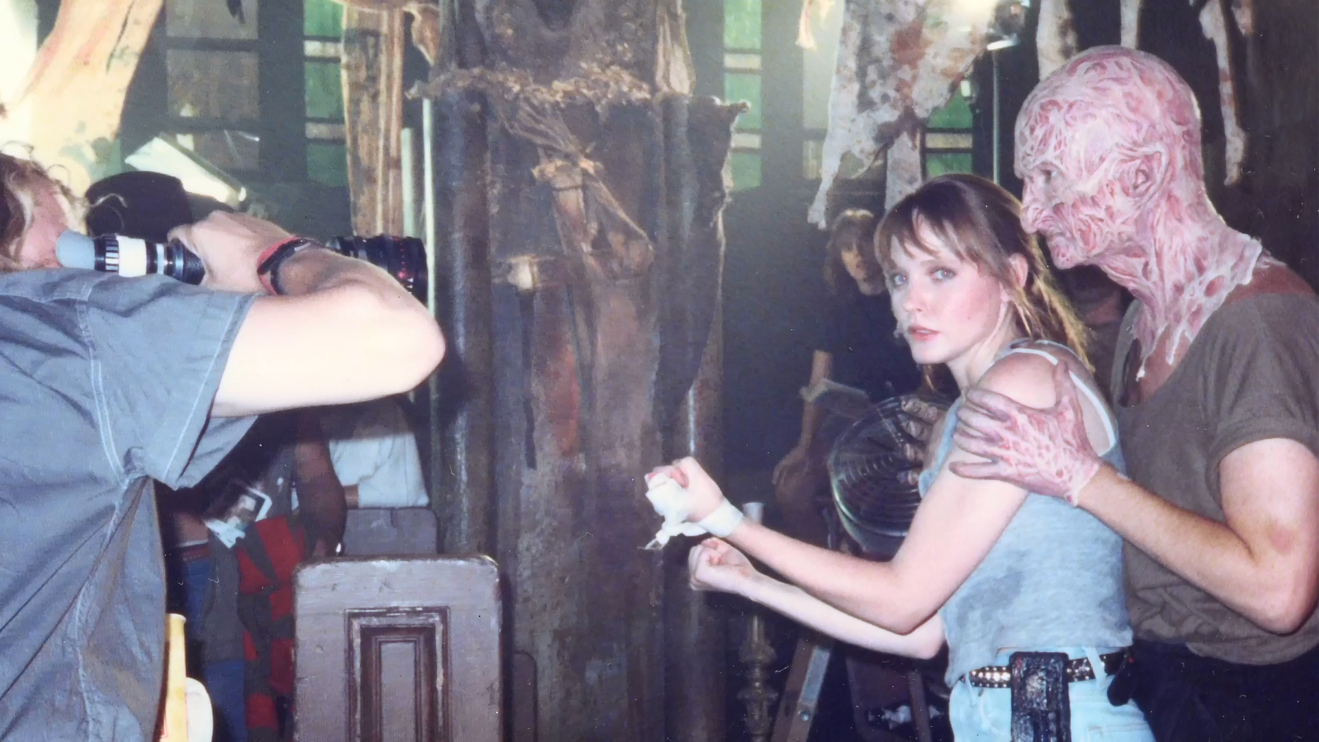 A camera operator photographs Lisa Wilcox and Robert Englund during the finale setup.
