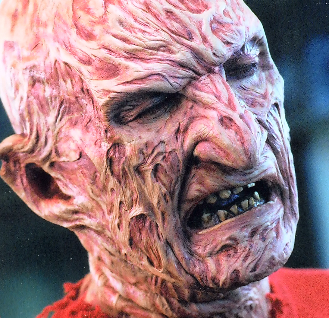 Close detail of the Freddy facial makeup with a torn-open cheek.