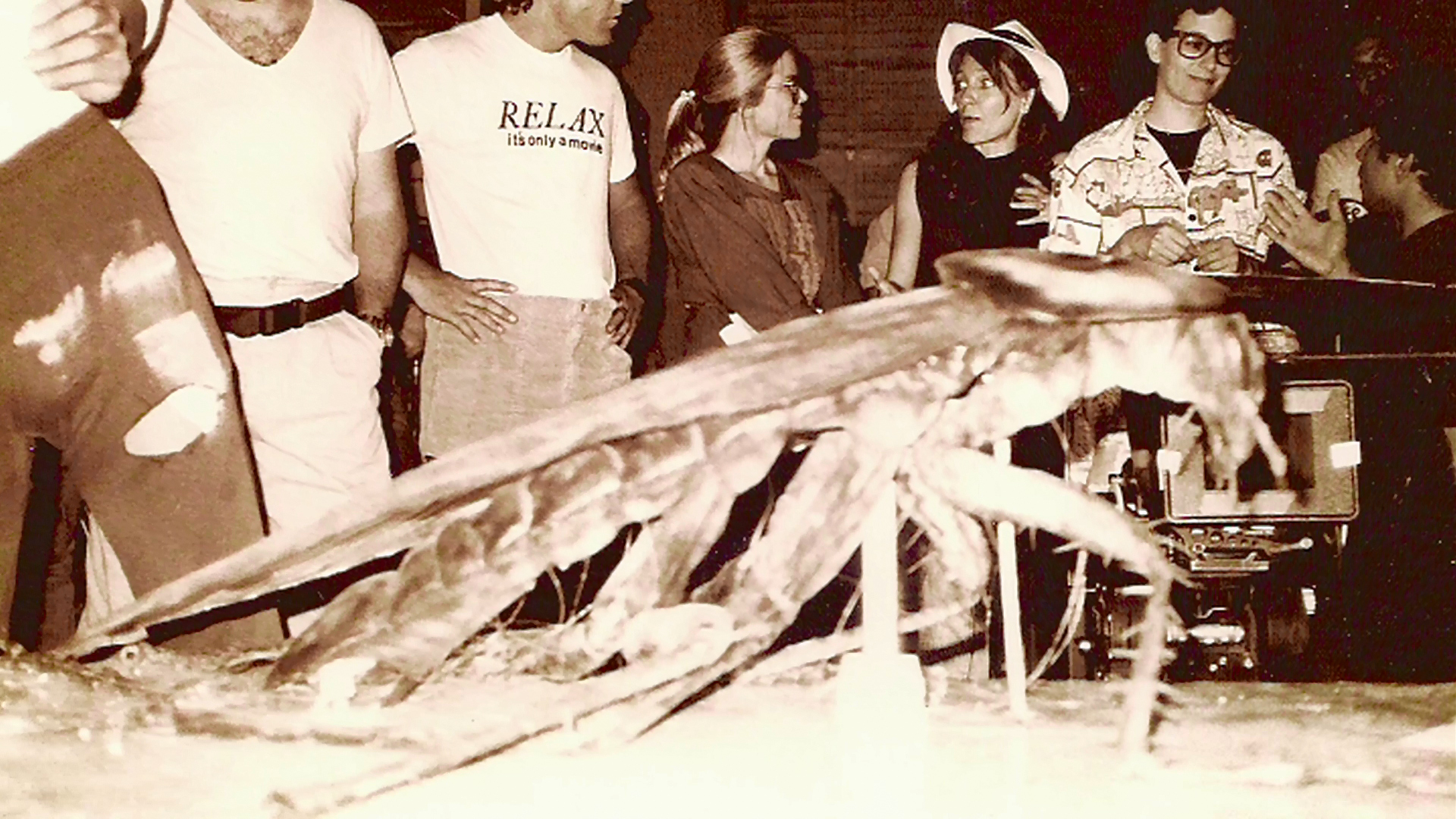Screaming Mad George's crew displays the large cockroach construction in the workshop.