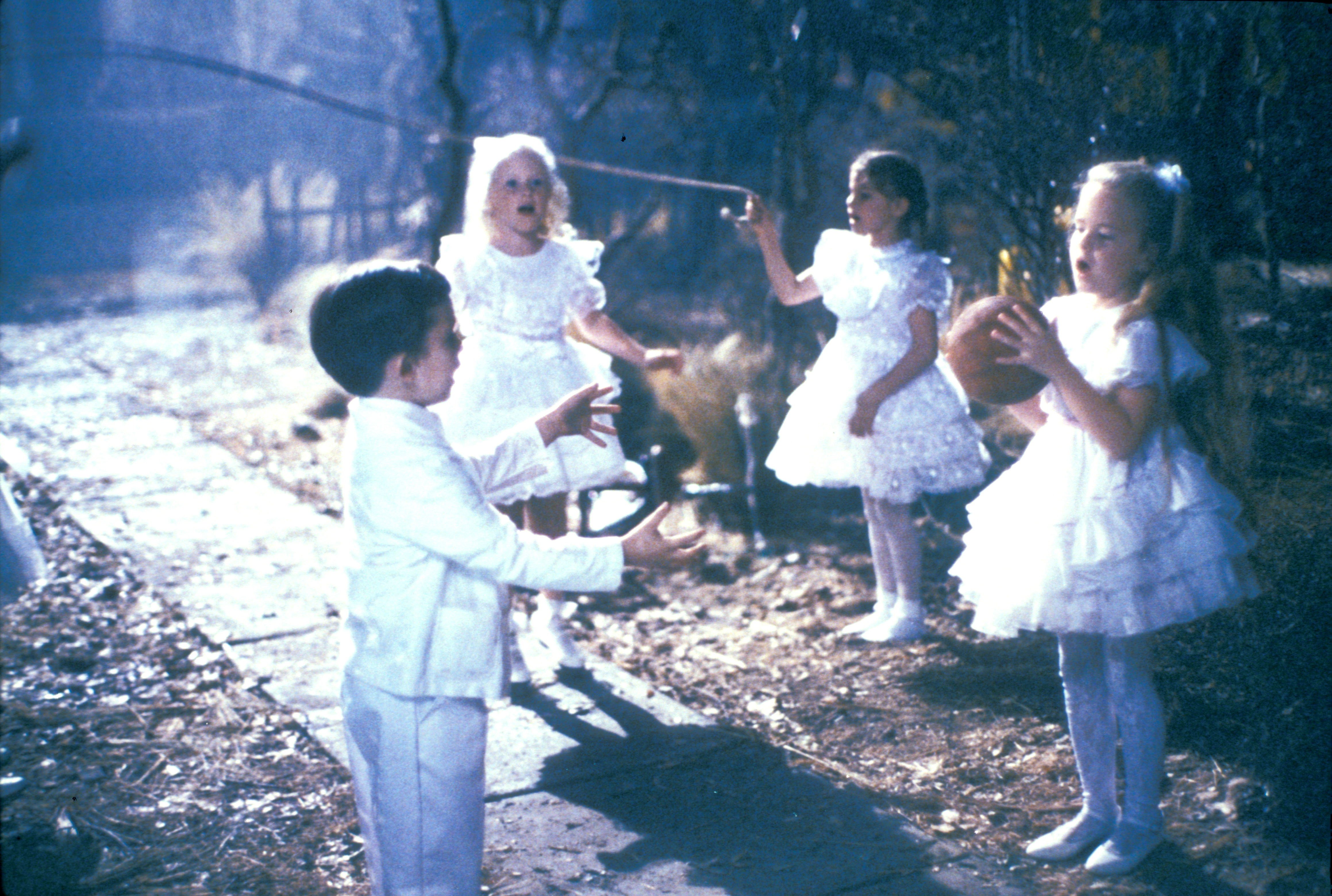 Children jumping rope outside the house.