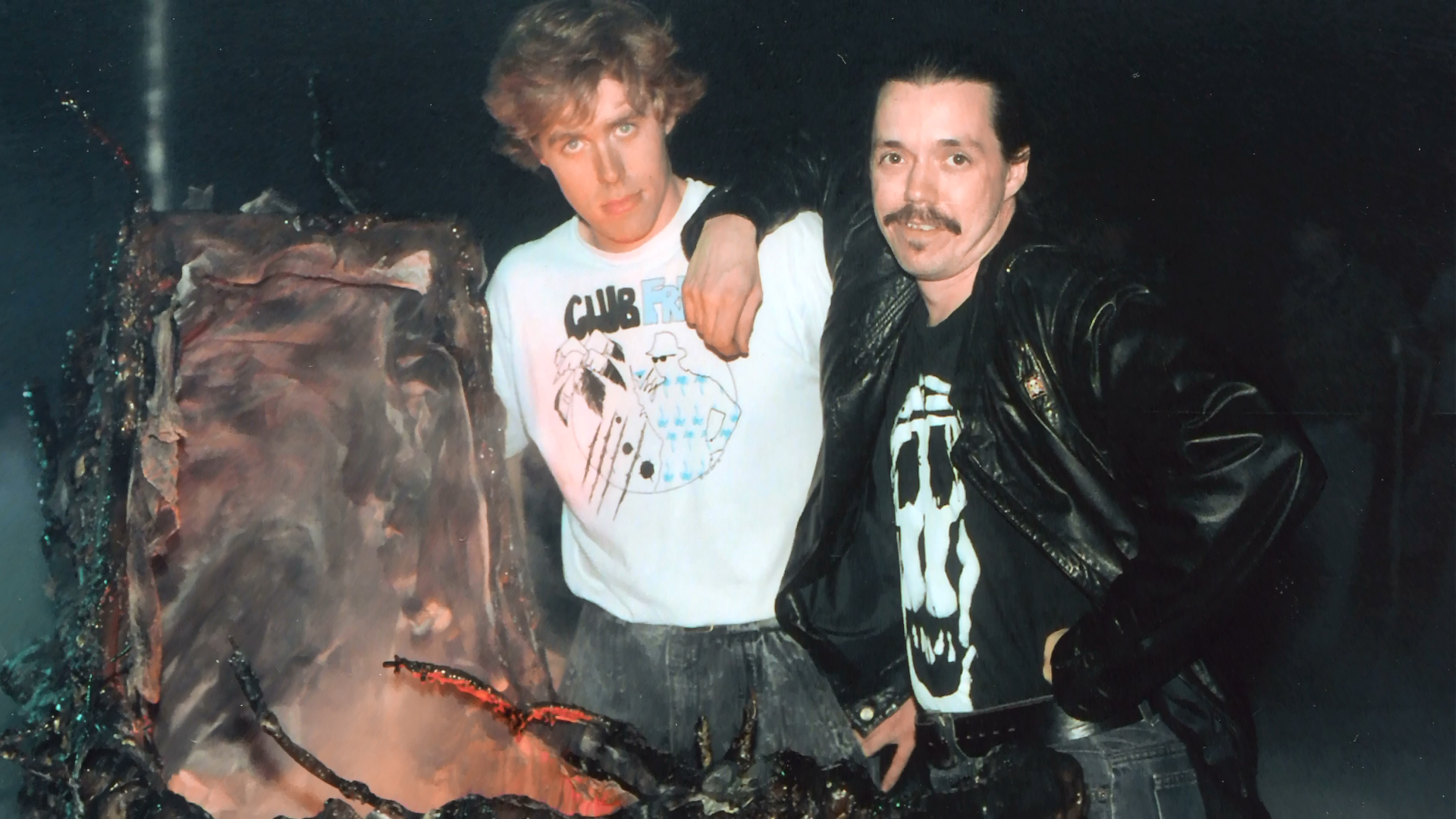 Crew members posed together beside the asylum set dressing.