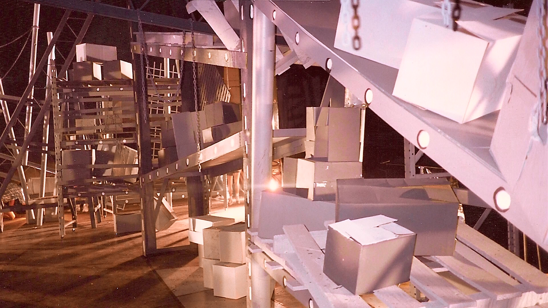 The unfinished staircase set showing structural beams, scaffolding and work materials.