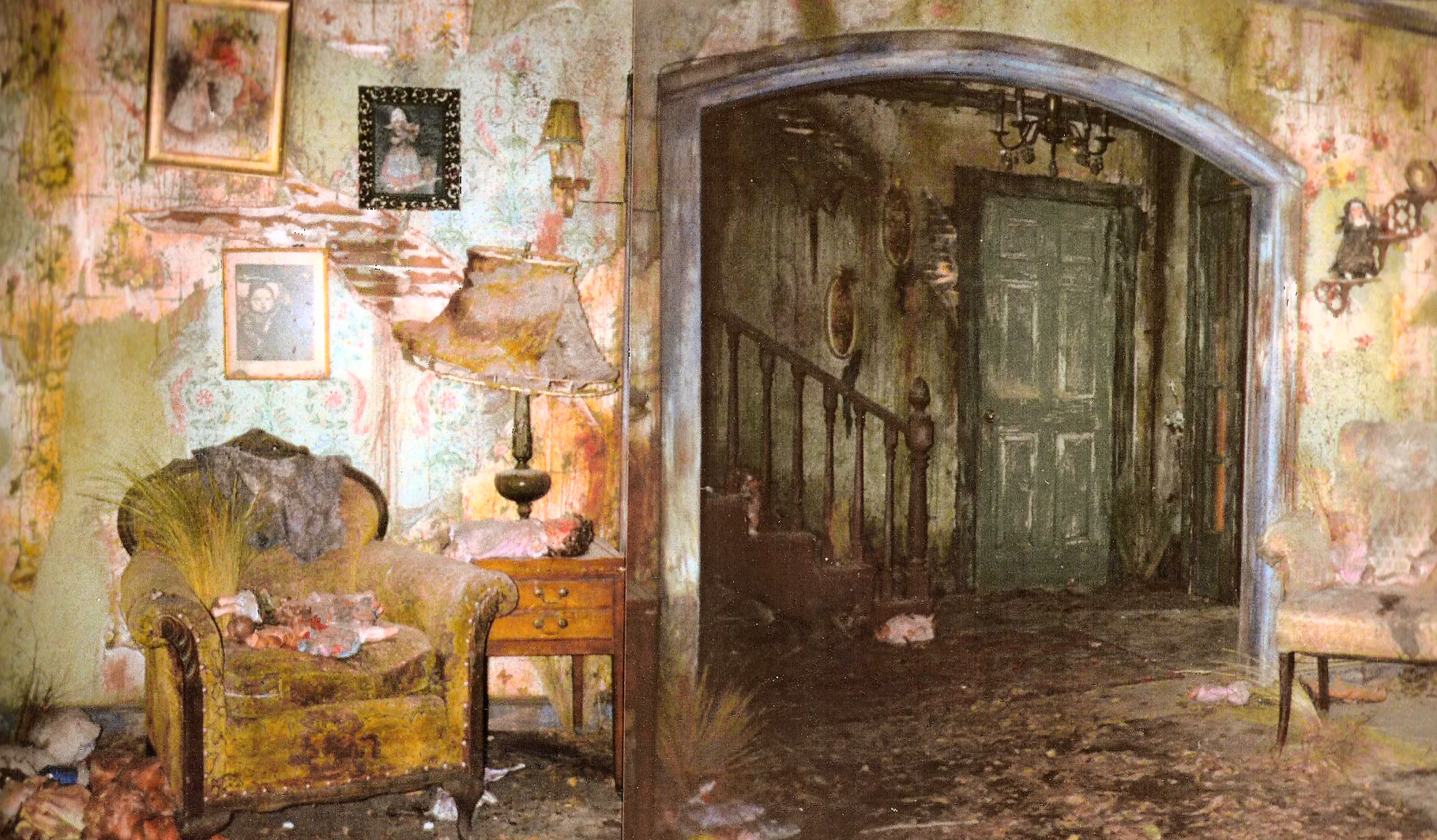 The distressed domestic interior set with floral wallpaper and the open archway.