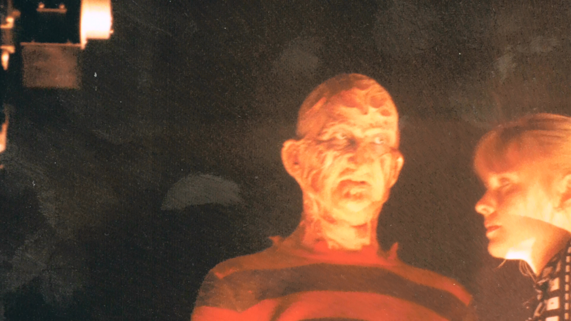Robert Englund and Lisa Wilcox waiting together beside the effects setup.