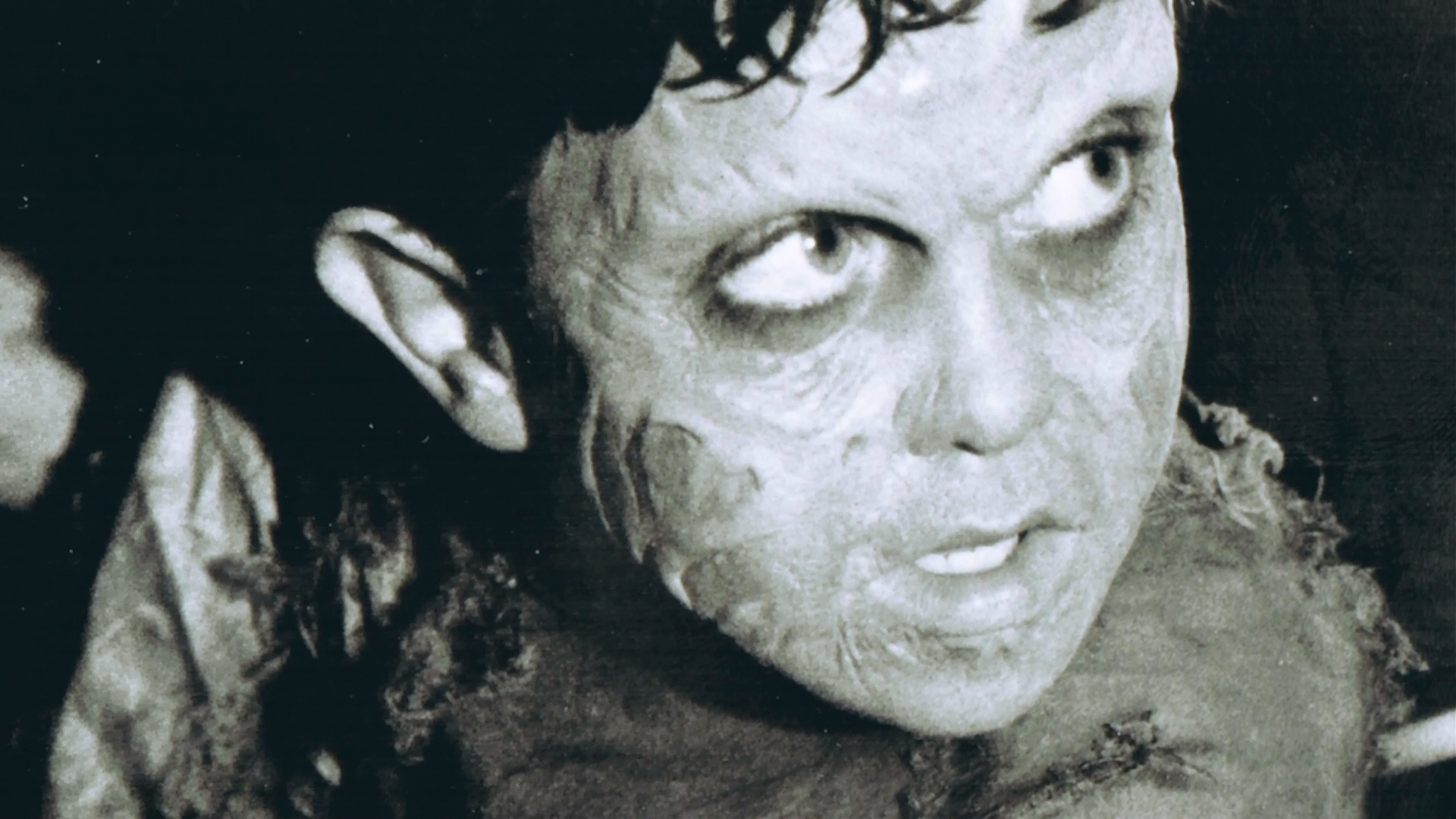 Jacob's discolored facial makeup photographed in close view.