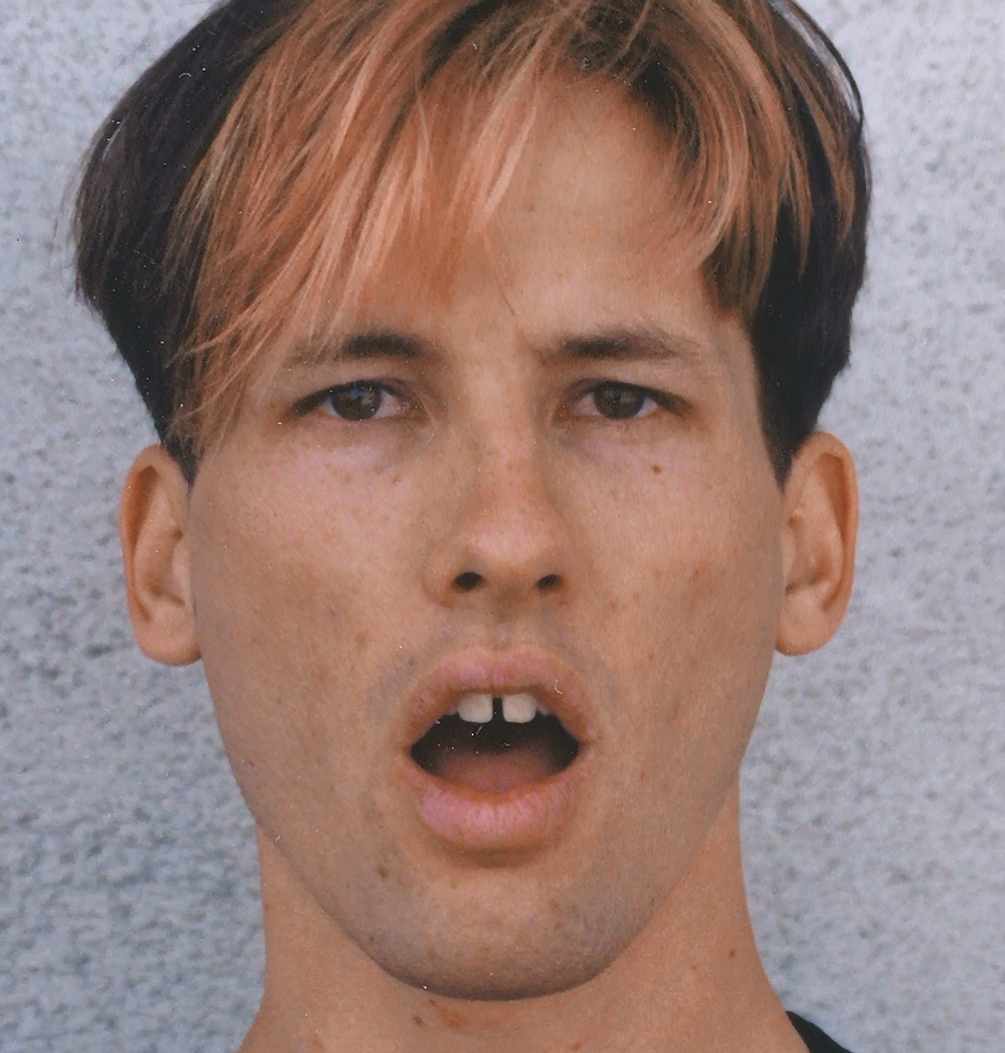 Photographic face reference used for the comic-world character artwork.
