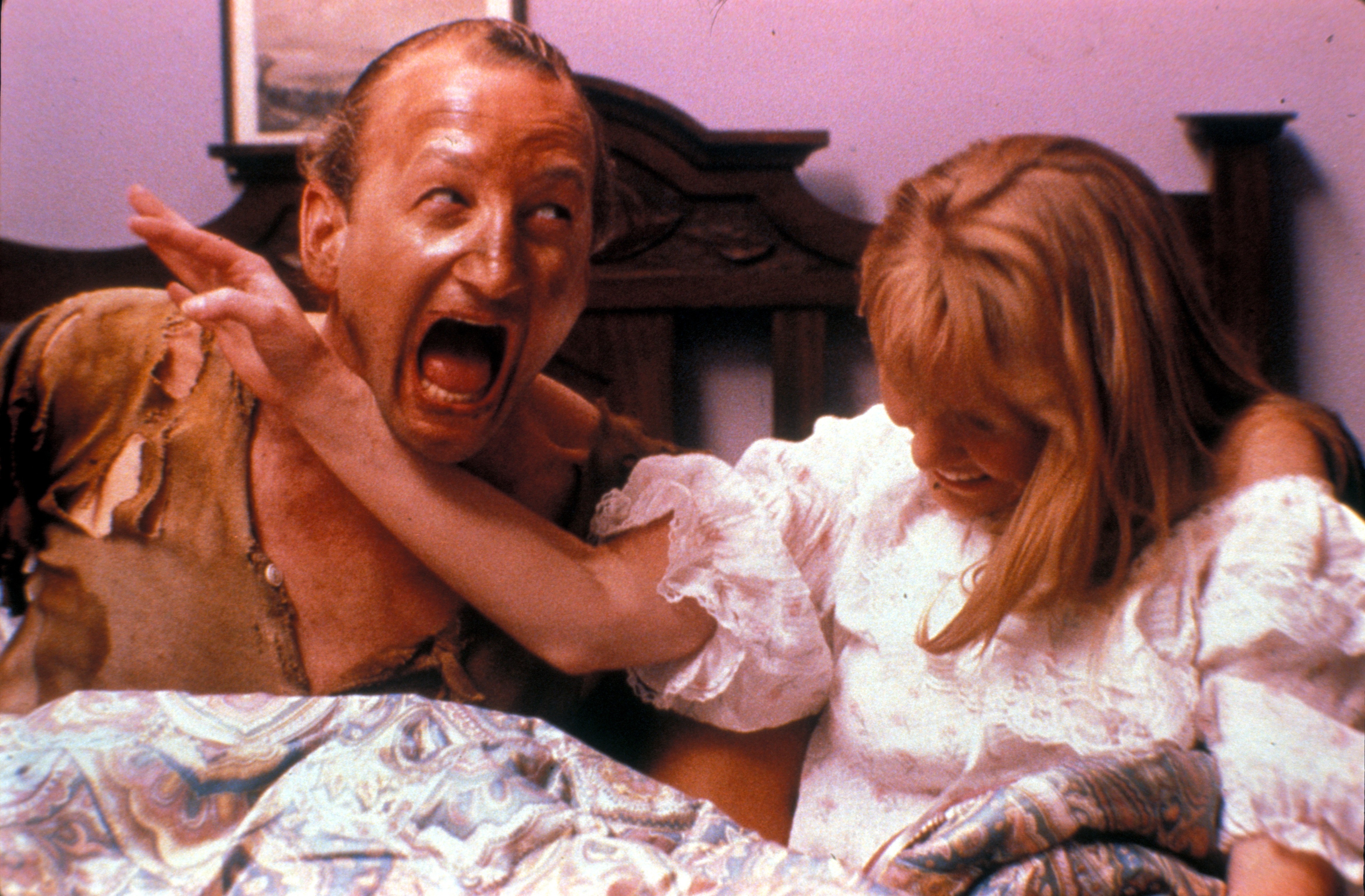 Freddy and Alice beside the bed.