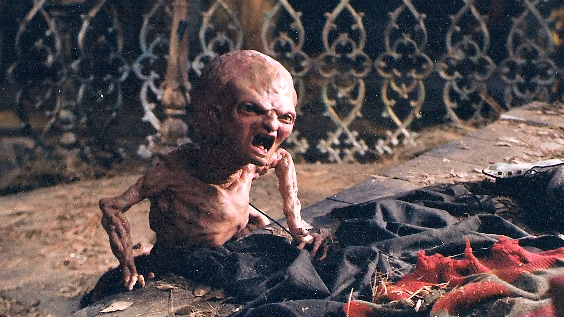 Baby Freddy emerging from the damaged clothing on the stone set.