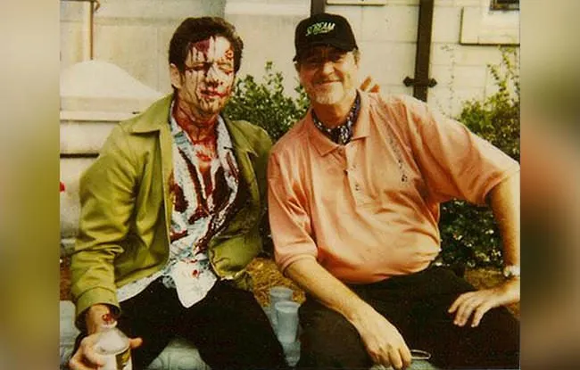 David Arquette in Dewey’s bloodied costume with Wes Craven between takes.
