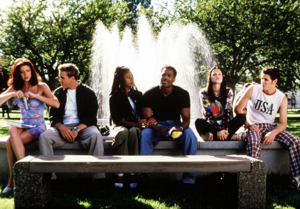 Friends sit outside the school.