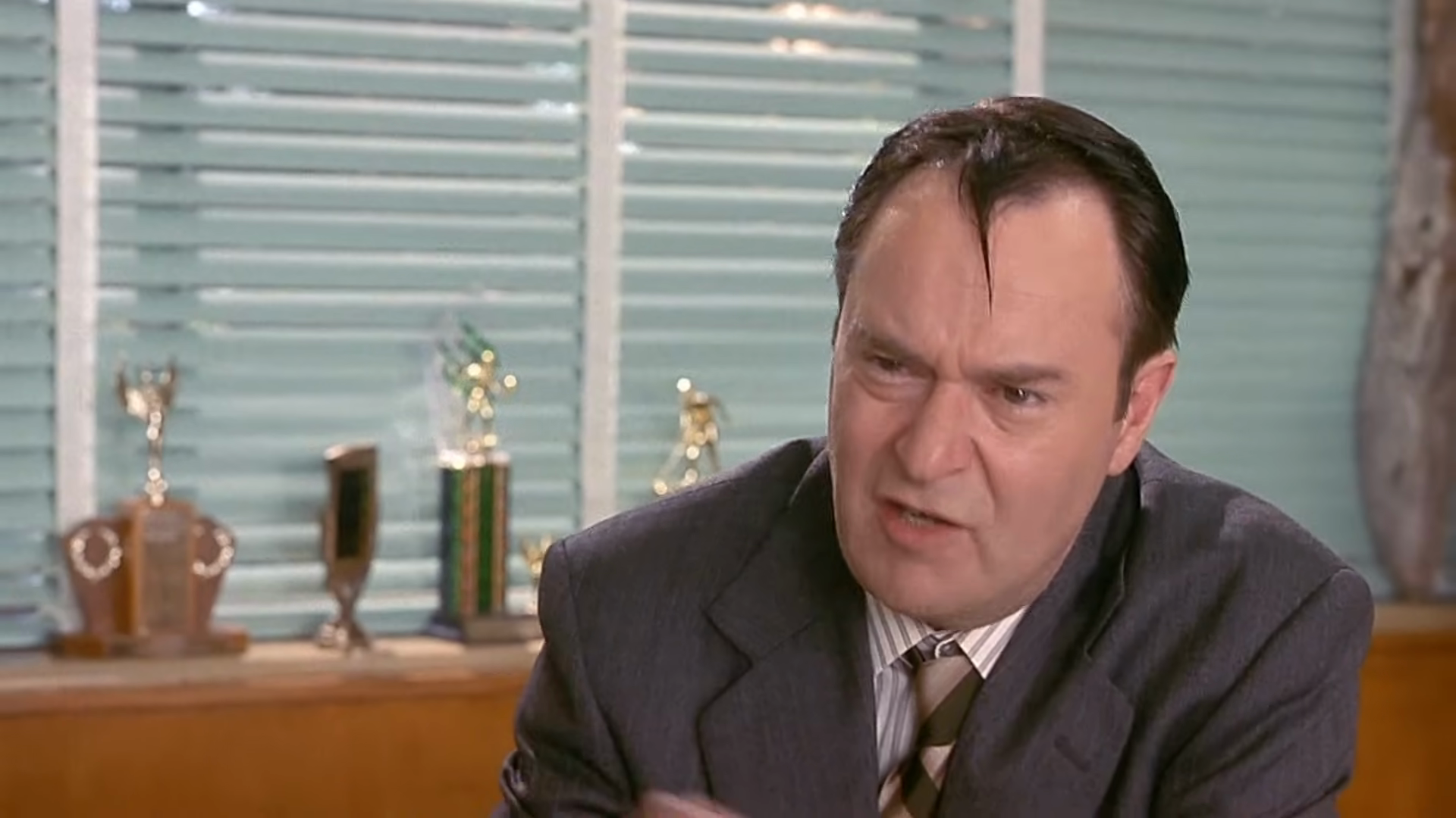 Police questioning in the principal’s office. Clip frame 00:32.