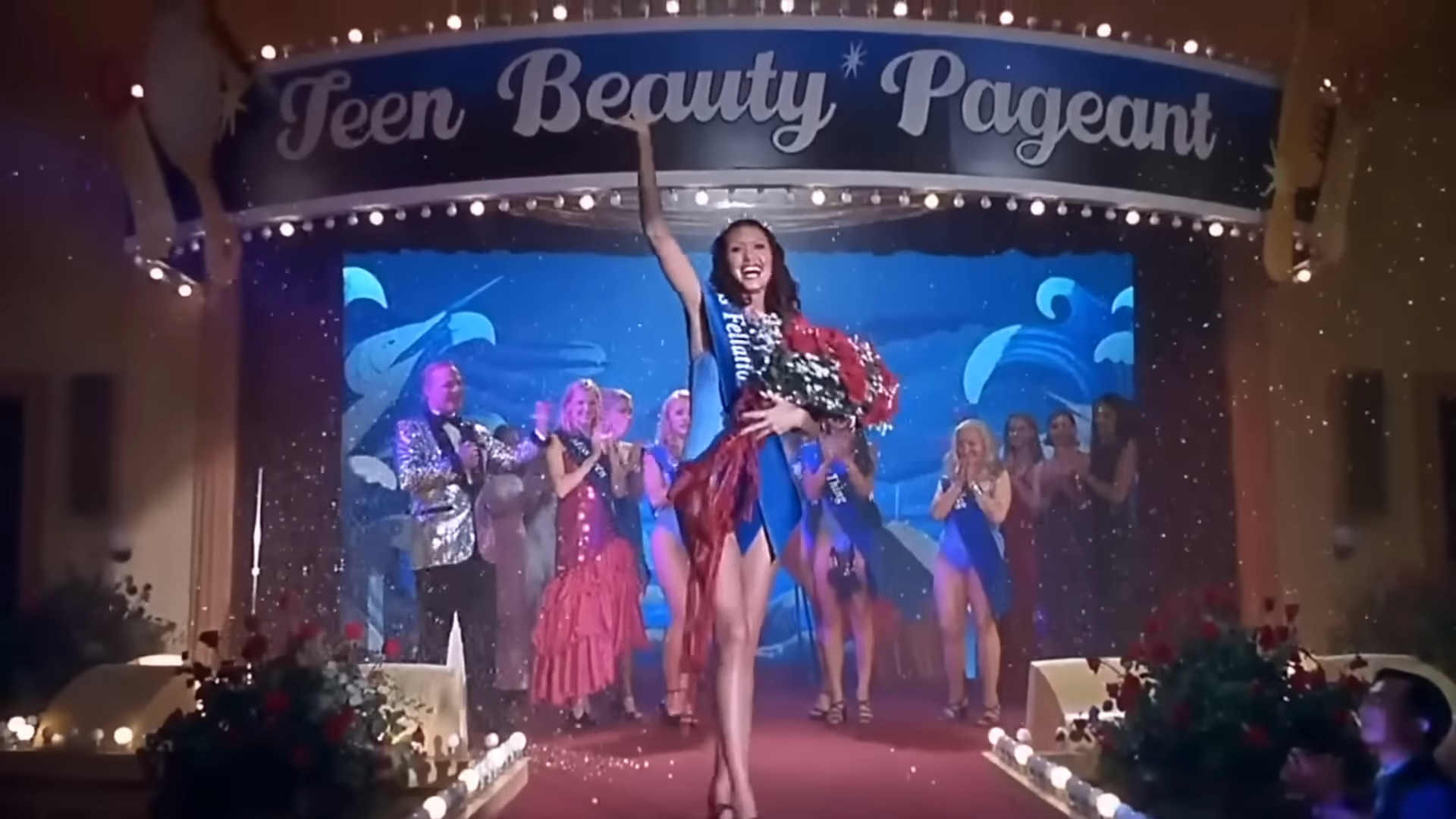 The beauty pageant. Clip frame 02:56.