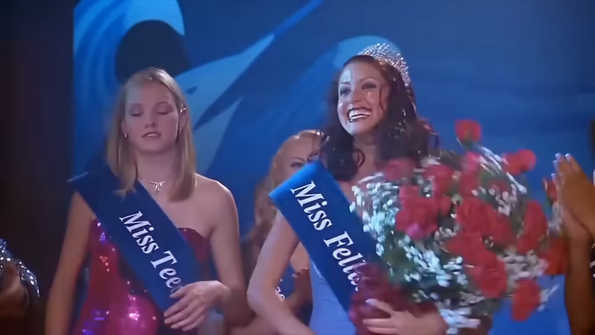 The beauty pageant. Clip frame 02:48.