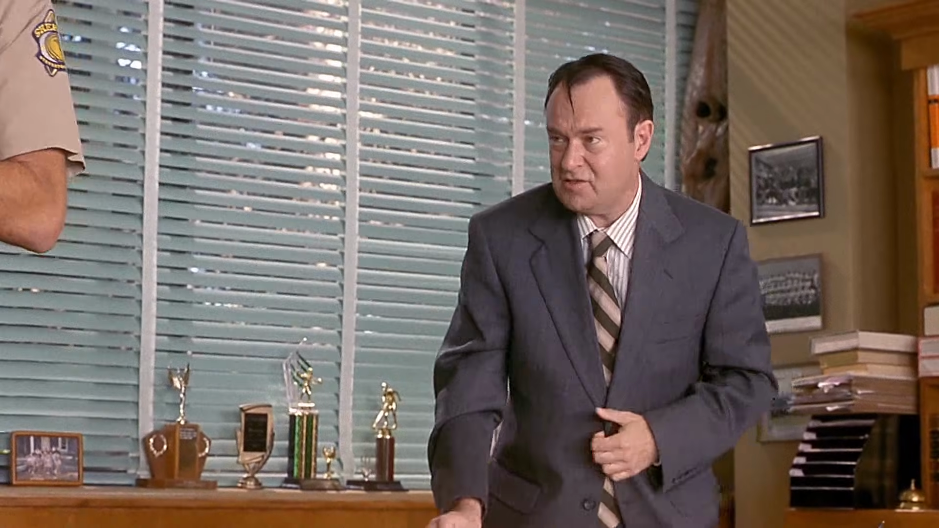 Police questioning in the principal’s office. Clip frame 00:24.