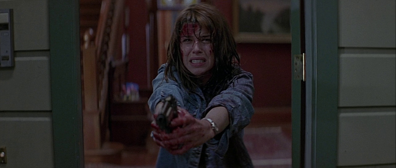 Sidney aiming a gun. Film frame.