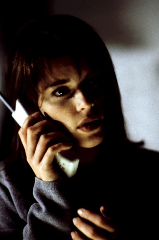 Sidney answers the telephone in shadow.