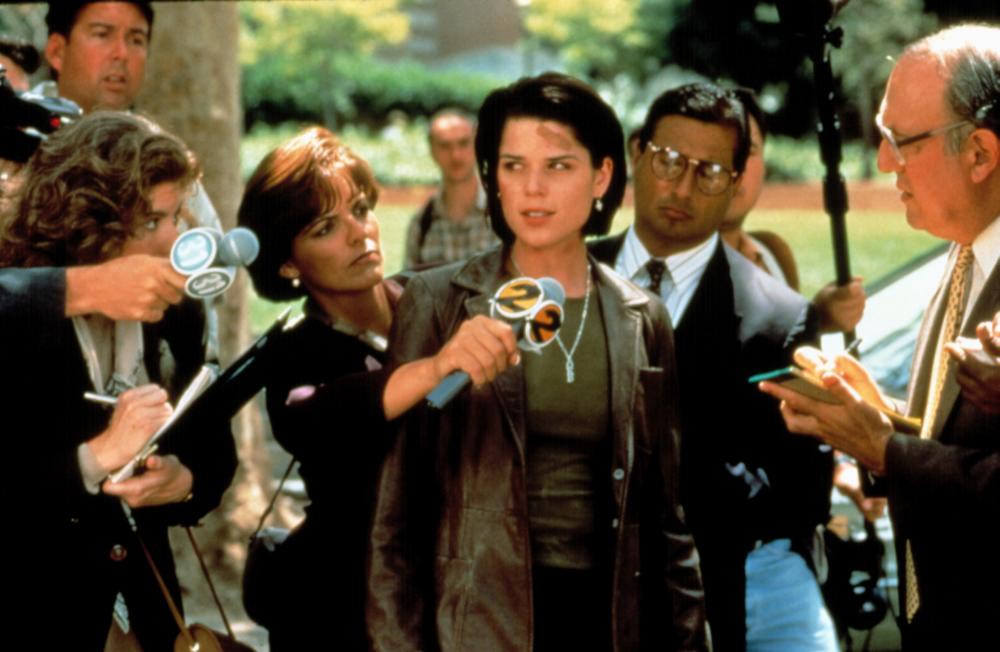 Sidney surrounded by reporters.