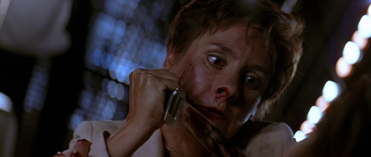 Mrs. Loomis holding a knife. Film frame.