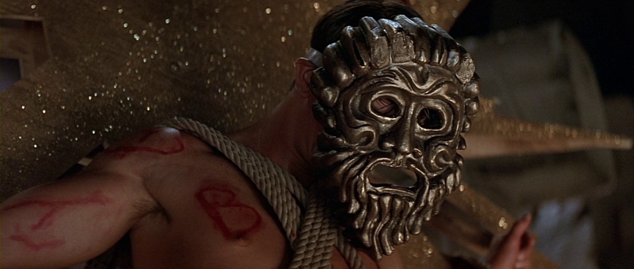 Derek wearing a stage mask. Film frame.