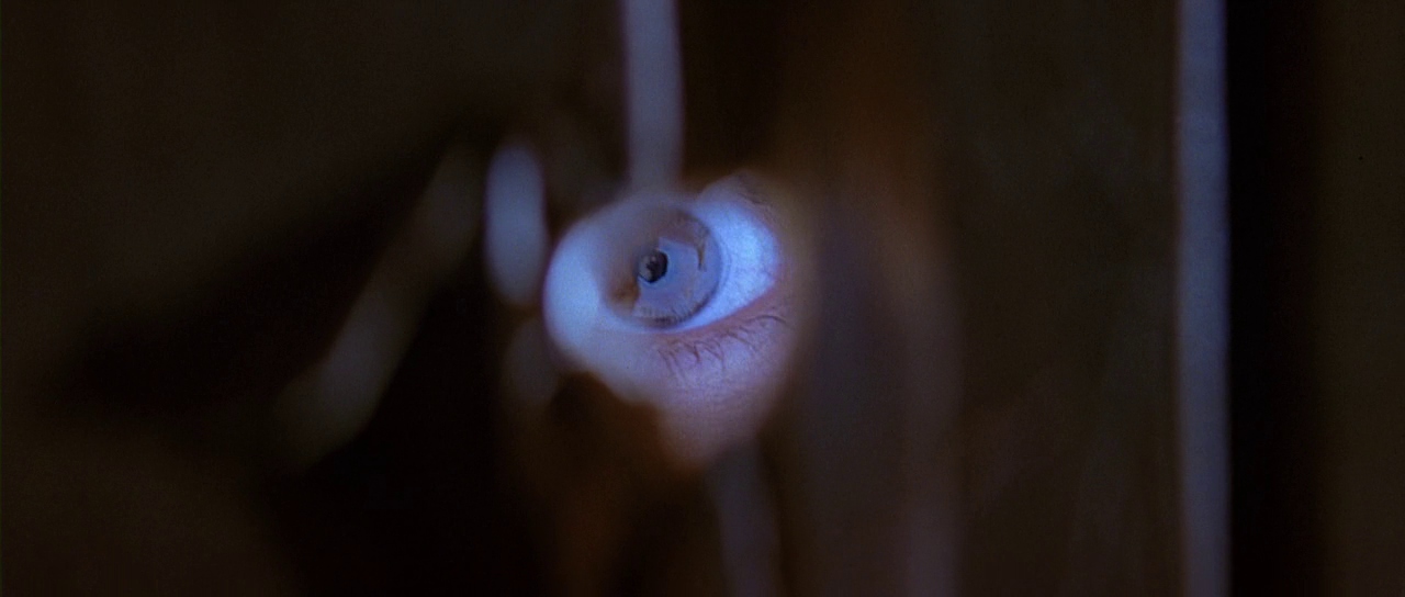 Eye seen through an opening. Film frame.