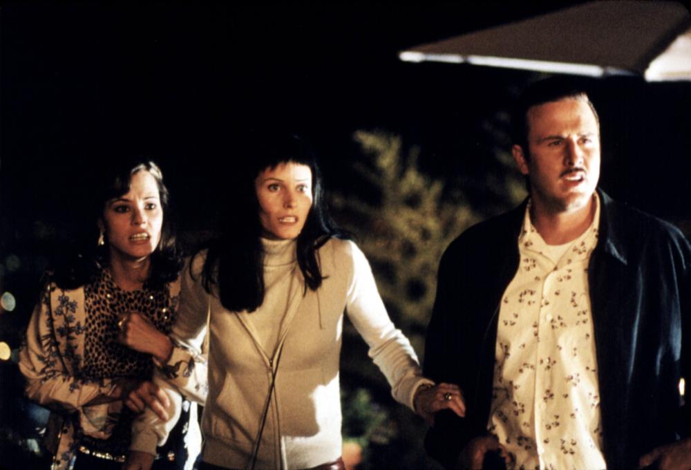 Three survivors outside the house.