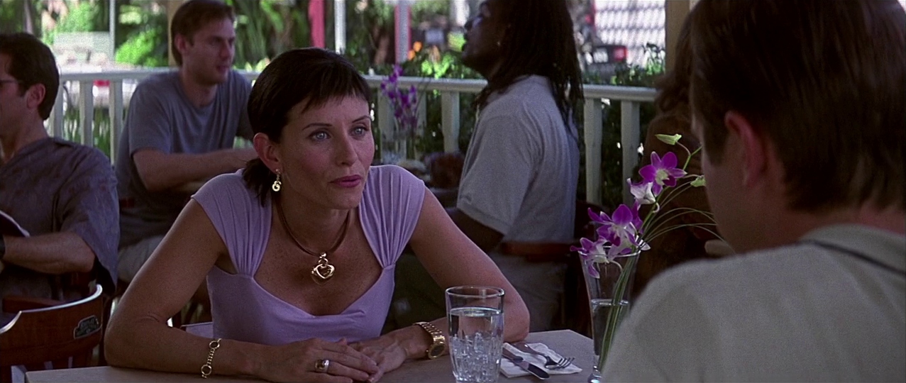 Gale and Dewey at an outdoor table. Film frame.