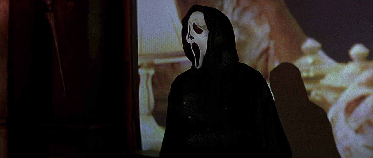 Ghostface in front of the projection. Film frame.