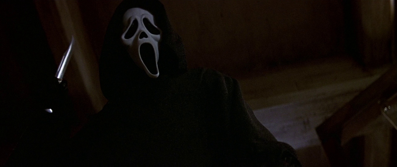 Ghostface holding a knife. Film frame.