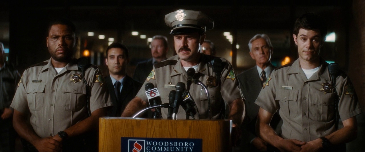 Dewey addressing reporters in a scene from the film. Film frame.